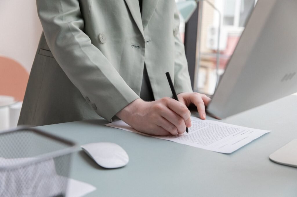 crop person writing in paper